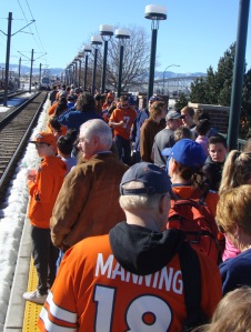 Denver fans of all ages wait for their light rail tickets. Eventually, RTD said "Screw it!" and let people ride for free.